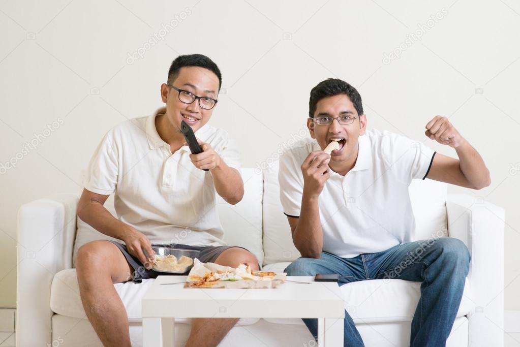 Men watching sport match on tv together