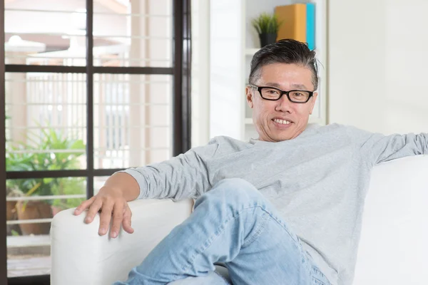 Mature Asian male sitting at home. — Stock Photo, Image