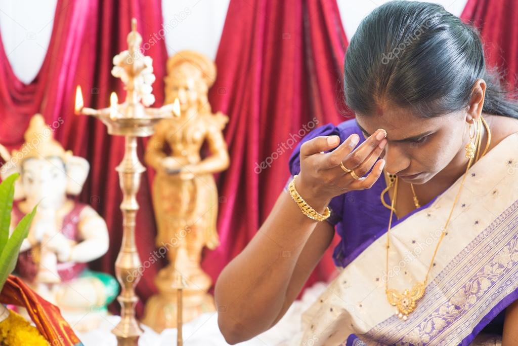 Hindu woman putting bindi 
