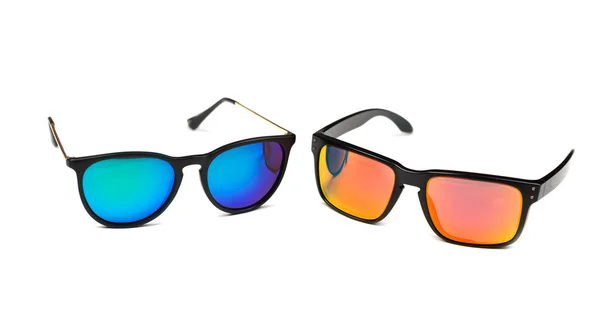 Two sunglasses, blue and yellow lens. — Stock Photo, Image