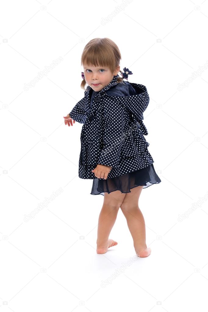 little girl in a polka dot raincoat isolate