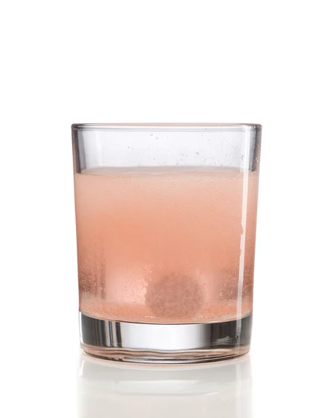 Comprimido y vaso naranja con agua —  Fotos de Stock