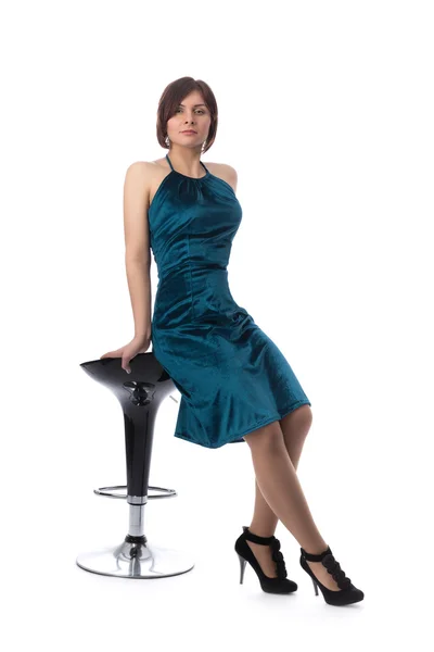 Girl on a bar chair in the studio, isolate — Stock Photo, Image