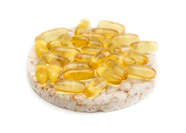 Sandwich from a round loaf and omega 3 pills. — Stock Photo, Image