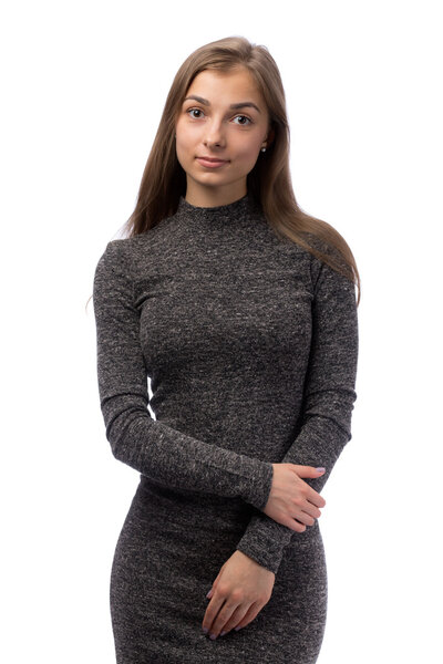 Slim charming girl in a gray dress in the studio.