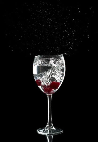 Three cherries in a glass drops splashing — Stock Photo, Image