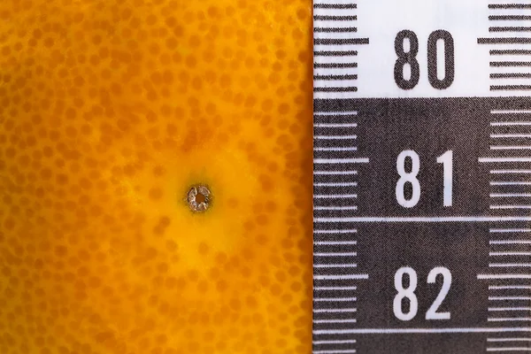 Orange with measuring tape — Stock Photo, Image