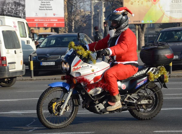 Undefined Santa delivering humanitarian aid in form of gifts to disabled children during annual Santa Claus Motorcycle Parade on 26 December 2015 in Belgrade, Serbia — Stock Photo, Image