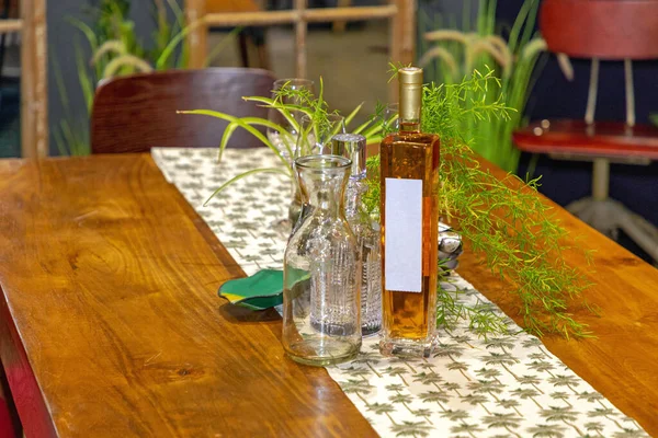 Flaschen Und Pflanzen Holztisch Mit Stoffdekor — Stockfoto