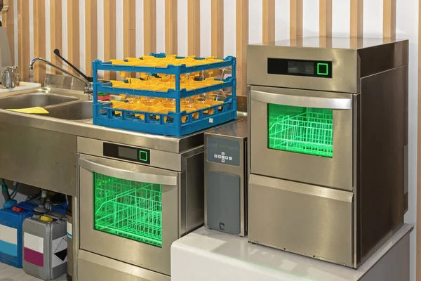 Two Dishwasher Machines With Glass Rack in Restaurant Kitchen
