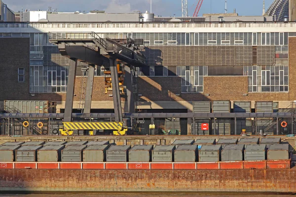 Environmental Waste Management Containers and Barge at Wharf in London