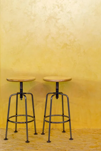 Two Metal Bar Stools Yellow Wall Background — Stock Photo, Image