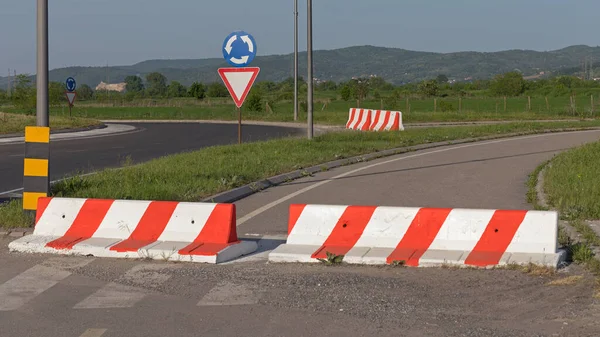 Concrete Barrier Closed Road to Roundabout Intersection