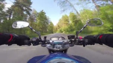 Orman yolu üzerinde bir motosiklet sürme
