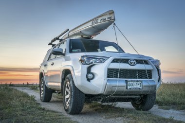 Toyota 4Runner SUV with canoe on roof clipart