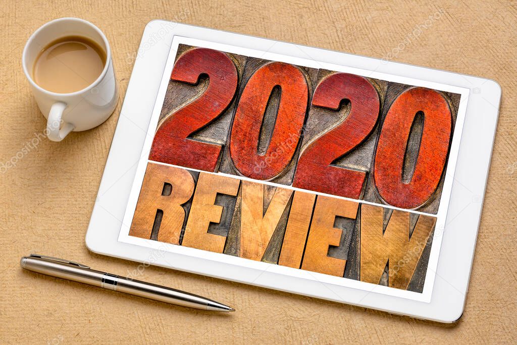 2020 year review banner - annual review or summary of the recent year - word abstract in letterpress wood type blocks on a digital tablet with a cup of coffee