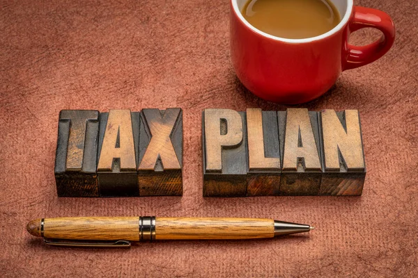 tax plan, financial concept in vintage letterpress wood type with coffee, business and tax optimization