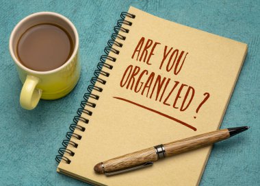 Are you organized? Handwriting in a spiral notebook with a cup of coffee. Business, productivity, lifestyle and personal development concept.