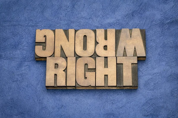 right or wrong ethical choice  dilemma - iword abstract in vintage wood letterpress printing blocks, ethics concept