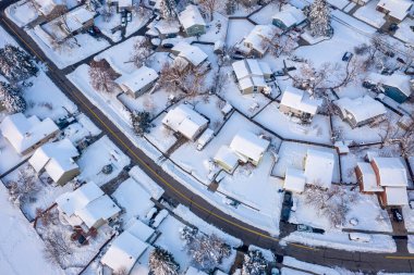 street in a residential area of Fort Collins in northern Colorado after heavy snowstorm, aerial view of late winter or early spring scenery