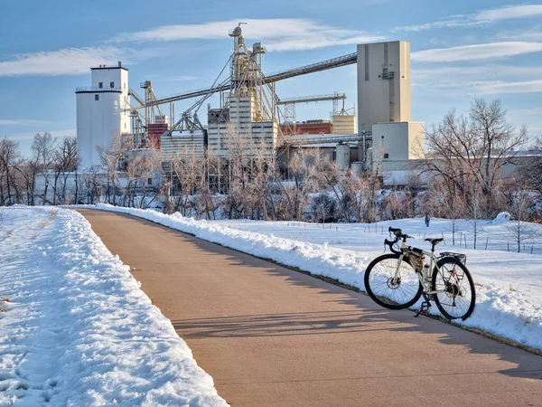 touring bike on a bike trail along the Poudre RIver in Fort Collins, Colorado, winter scenery. recreation and commuting concept