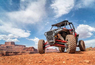 MOAB, UT, USA - MAY 7, 2017: Polaris RZR ATV on a popular Chicken Corner 4WD trail in the Moab area. clipart