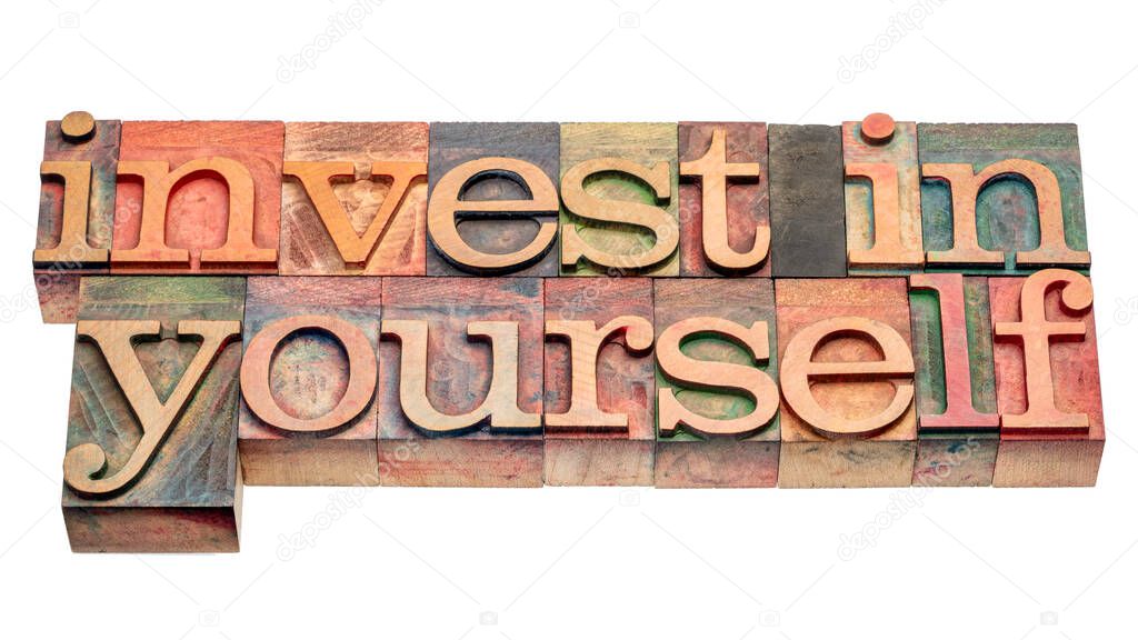 invest in yourself - isolated word abstract in vintage letterpress wood type, self improvement and personal development concept