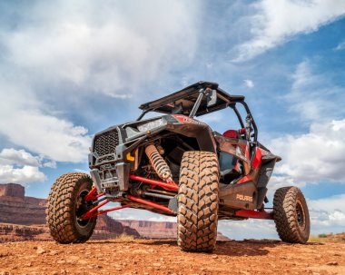 MOAB, UT, USA - MAY 7, 2017: Polaris RZR ATV on a popular Chicken Corner 4WD trail in the Moab area. clipart