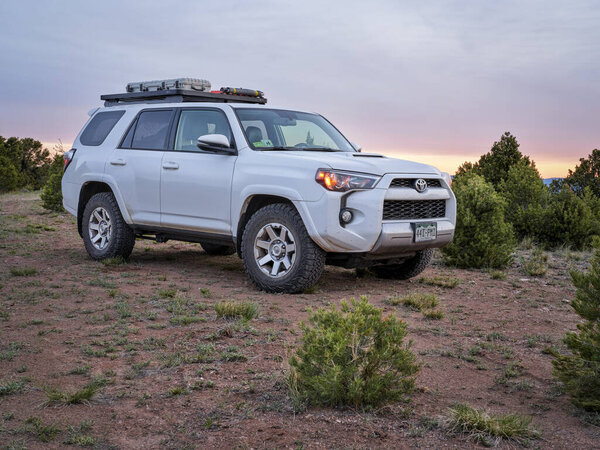 Dinosaur National Monument, CO, USA - May 18, 2021: Toyota 4Runner SUV (2016 Trail model) at dawn in arid landscape of north western Colorado along Yampa Bench Road, springtime morning scenery.