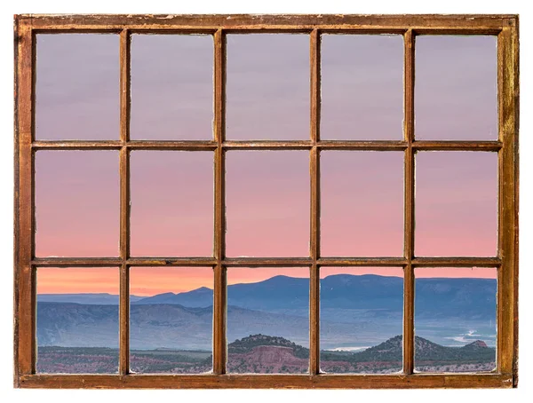 colorful sky at dawn in north western Colorado as seen from a vintage cabin window