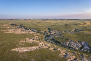 morning light over arroyo and badlands in Pawnee National Grassland in northern Colorado, early summer scenery aerial view of Main Draw area clipart