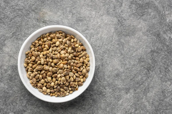 Hemp Seed Small Ceramic Bowl Top View Handmade Paper Background — Fotografia de Stock