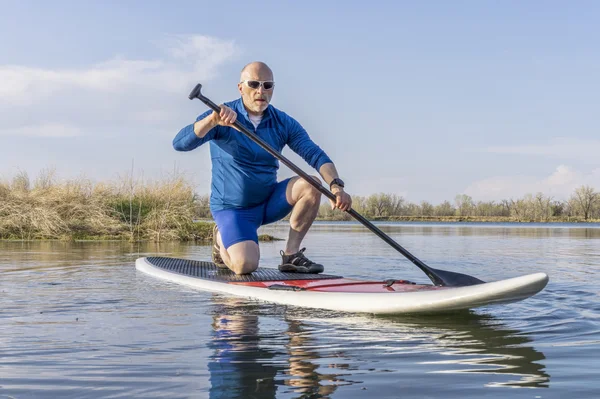 Senior male on SUP paddleboard — Stock Photo, Image