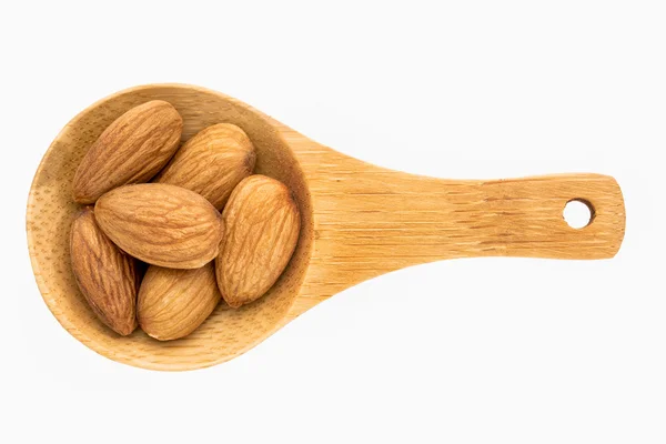 Almond nuts on wooden spoon — Stock Photo, Image