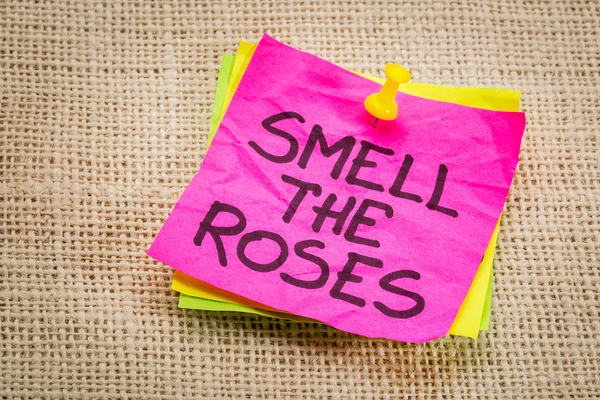Smell the roses reminder note — Stock Photo, Image