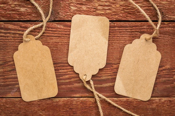 Blank paper price tags on rustic wood — Stock Photo, Image