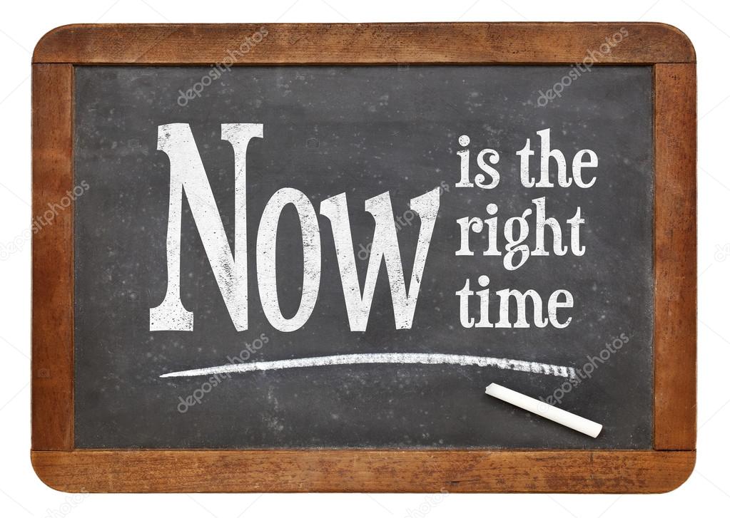 Now is the right time- motivational phrase on a vintage slate blackboard