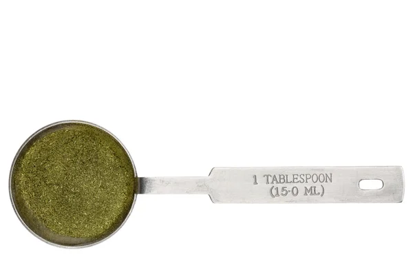 Wheatgrass powder in a tablespoon — Stock Photo, Image