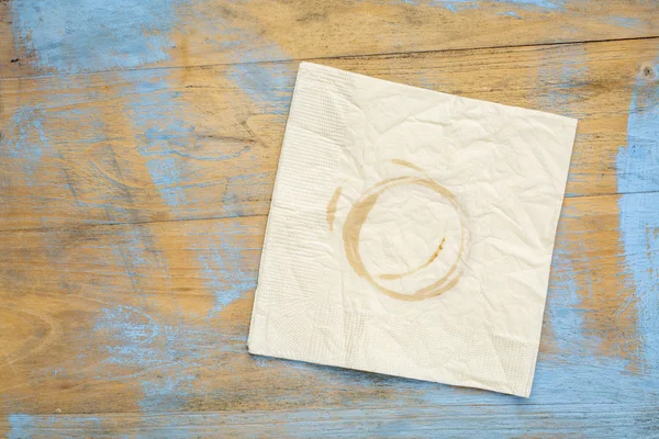 Napkin with coffee stains on wood — Stock Photo, Image