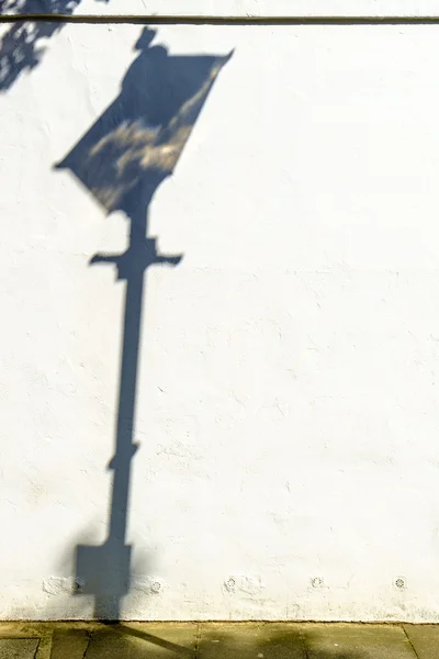 Public lamp shadow in a street Stock Picture