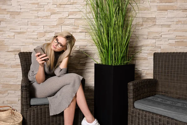 Preciosa mujer usando teléfono móvil en una sala de espera —  Fotos de Stock