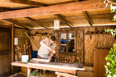 Historic carpenter in his workshop clipart