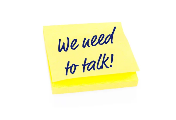 Yellow sticky note on block with text We Need To Talk — Stock Photo, Image