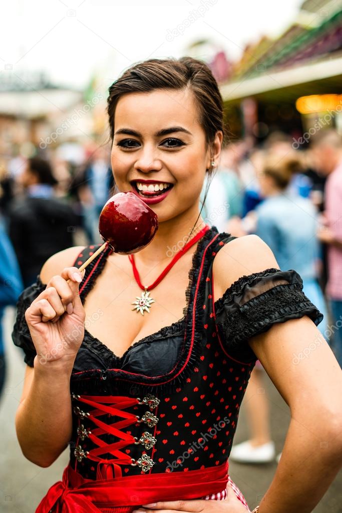 Attractive young woman with love apple at the Oktoberfest