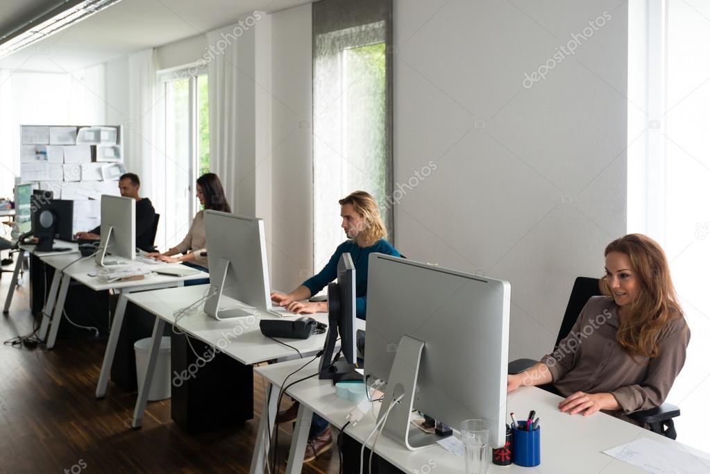 Young team working at desks in stylish office