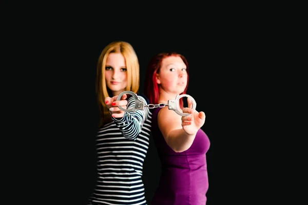 Two young women with handcuffs — Stock Photo, Image