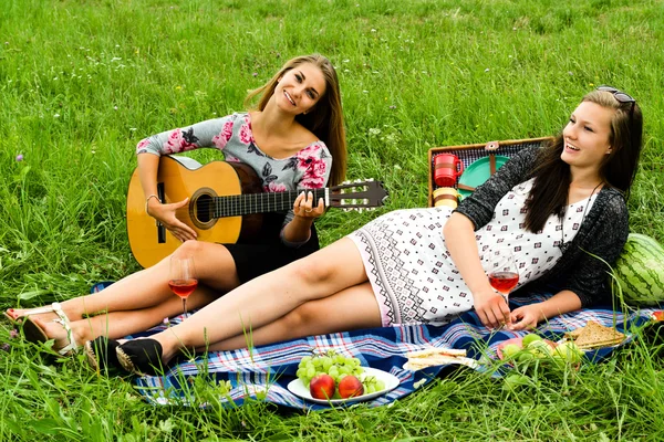 两个女孩与吉他在野餐 — 图库照片