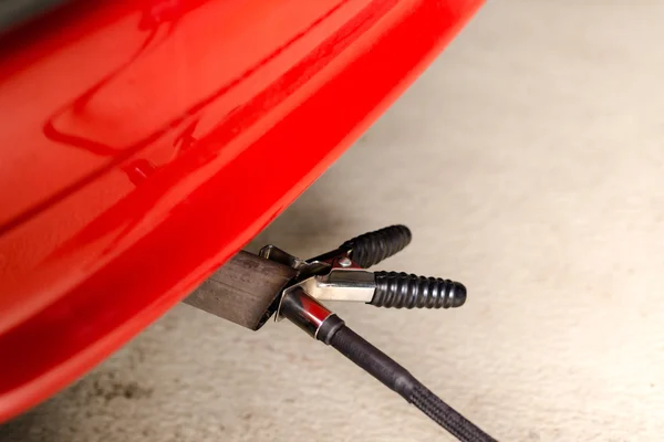 Measuring exhausts of a car in garage — Stock Photo, Image