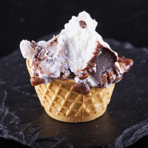 Ice cream over black stone — Stock Photo, Image