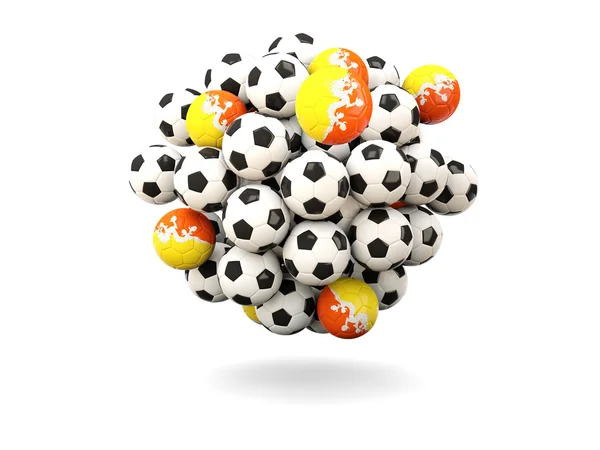 Mucchio di palloni da calcio con bandiera del bhutan — Foto Stock